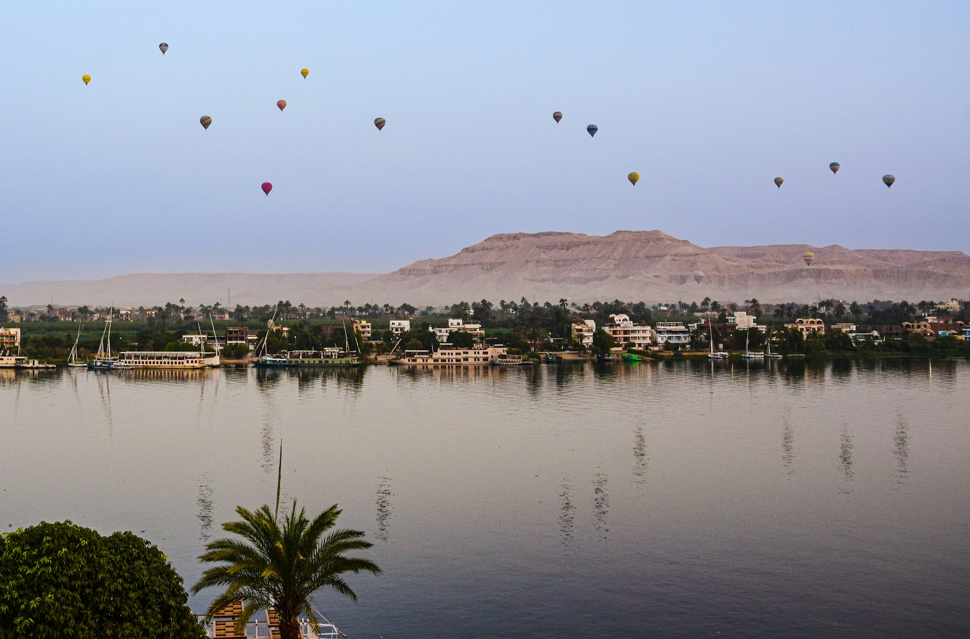 a group of hot air balloons over a city